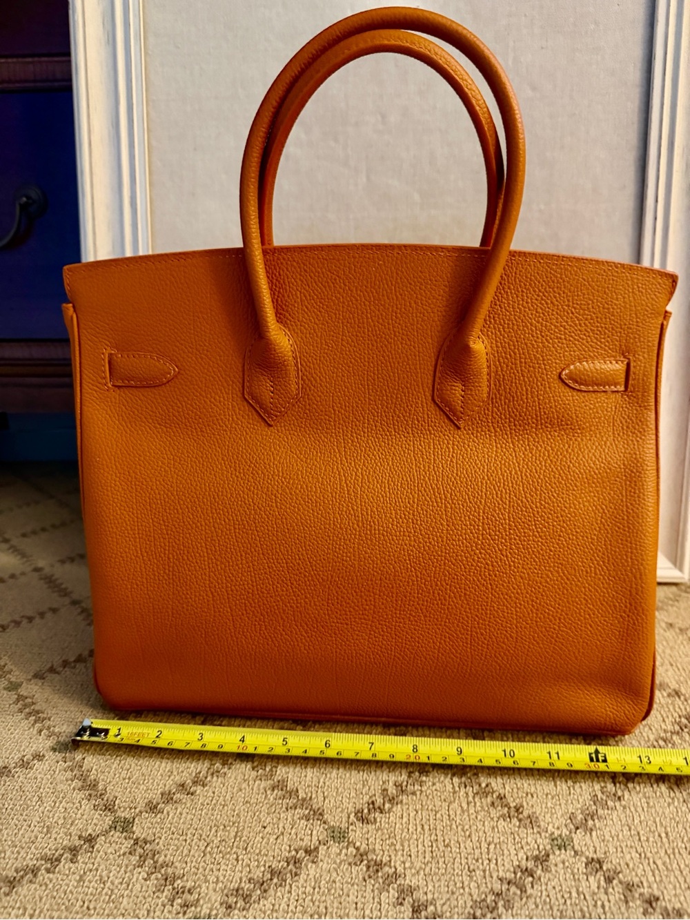 Orange double handled satchel with silver hardware